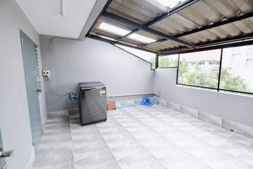 Bright utility area with washing machine and tiled flooring