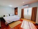 Modern bedroom with hardwood floor and large windows