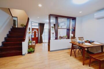 Cozy living space with dining area and staircase