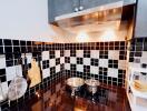 Modern kitchen with black and white tiled backsplash