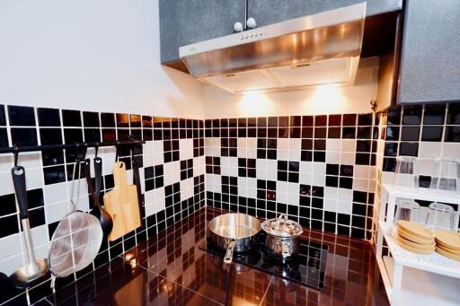 Modern kitchen with black and white tiled backsplash