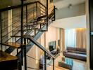 Stylish living room with a modern staircase and large windows.