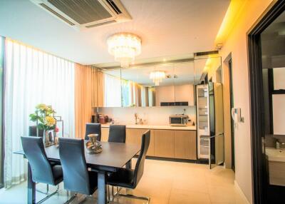 Modern kitchen with dining area and contemporary lighting