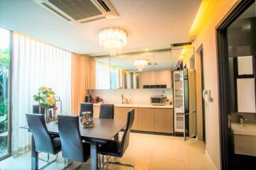 Modern kitchen with dining area and contemporary lighting