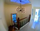 Bright staircase with chandelier in modern home