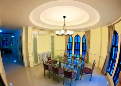 Dining area with glass table and modern light fixture