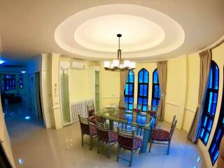 Dining area with glass table and modern light fixture