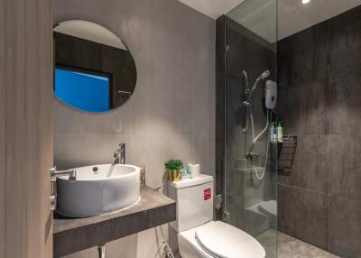 Modern bathroom with shower and round mirror