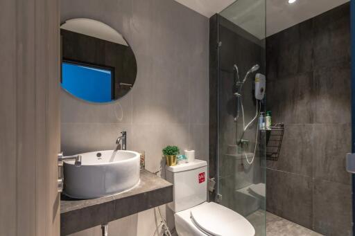 Modern bathroom with shower and round mirror