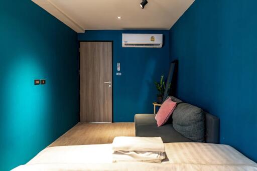 Bedroom with blue walls and air conditioner