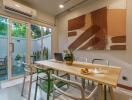 Dining area with sliding glass doors, modern art, and air conditioning.