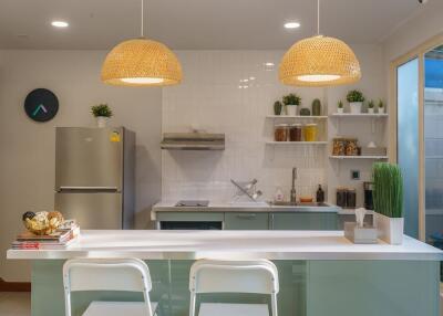 Modern kitchen with counter seating and stainless steel appliances