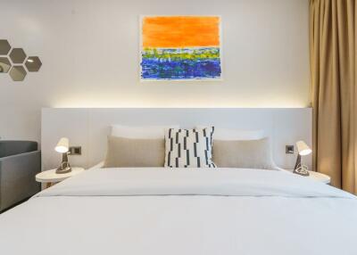 Modern bedroom with contemporary art and bedside lamps