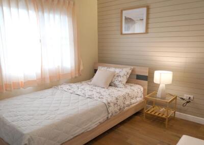 Cozy bedroom with a window, bed, and nightstand