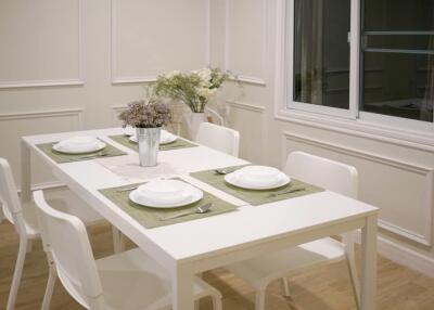 Modern dining area with white table and chairs