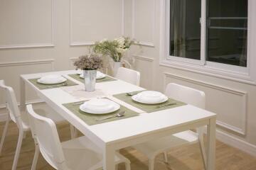 Modern dining area with white table and chairs