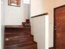 Hallway with wooden stairs and wall art