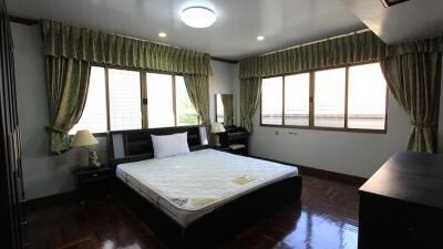 Spacious bedroom with large windows and natural lighting