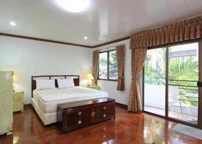 Spacious bedroom with large windows and balcony access