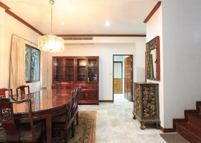 Spacious dining room with wooden furniture and elegant decor