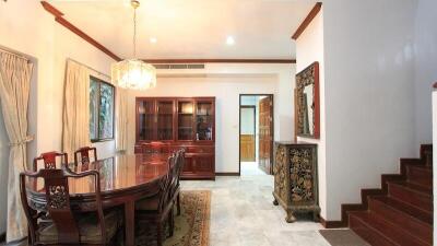 Spacious dining room with wooden furniture and elegant decor