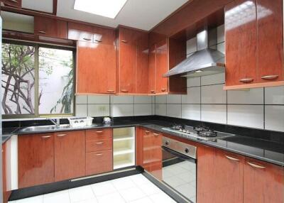 Modern kitchen with wooden cabinets and black countertops