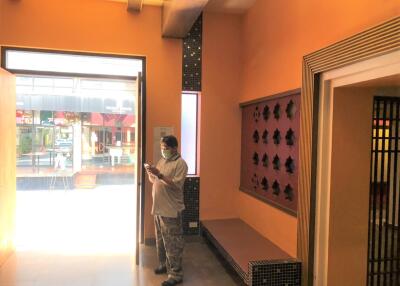 Person in lobby area with orange walls