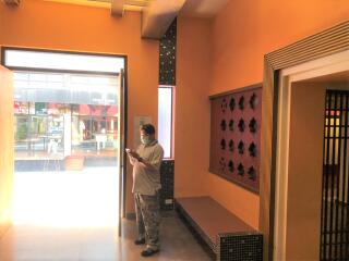 Person in lobby area with orange walls