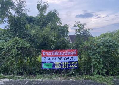 Vacant land with for sale sign and contact information