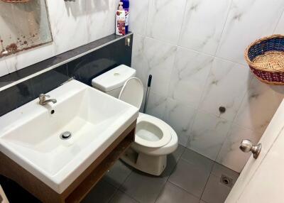 Bathroom with sink, toilet, and mirror