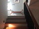 Indoor staircase leading to a landing area with a decorative bench and framed artwork