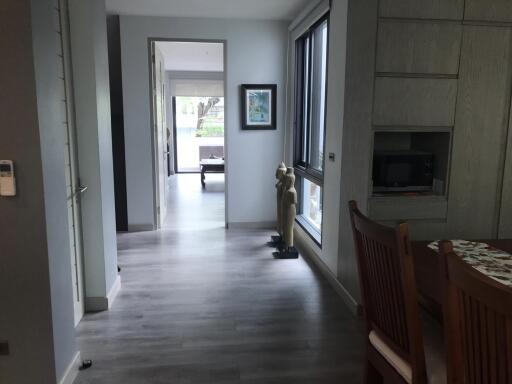 Modern hallway with wooden flooring leading to other rooms