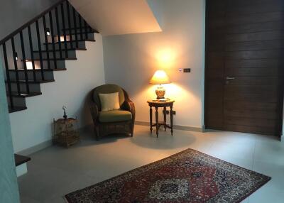 Cozy corner in a living area with a chair, lamp, and rug