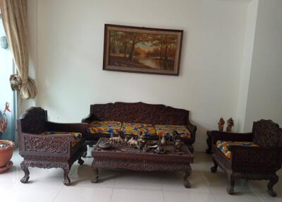 Living room with wooden carved furniture and wall painting