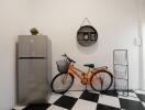 Utility area with refrigerator, bicycle and shelving unit