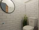 Modern bathroom with tiled walls and round mirror