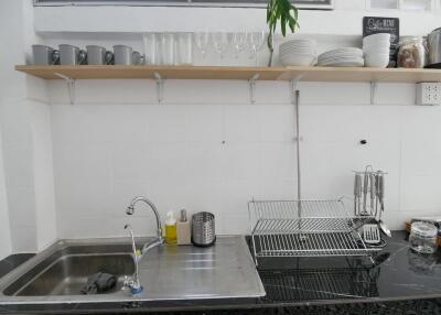 Modern kitchen sink area with dishes and glasses