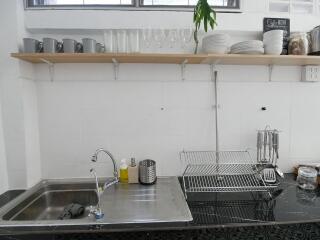 Modern kitchen sink area with dishes and glasses