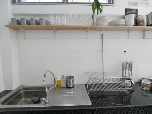 Modern kitchen sink area with dishes and glasses