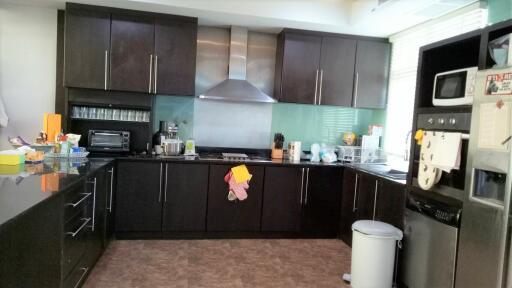 Modern kitchen with dark cabinets and stainless steel appliances