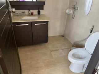 Bathroom with sink, mirror, and toilet