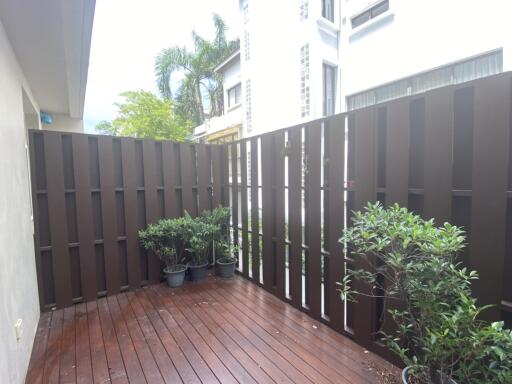 Balcony with wooden flooring and potted plants