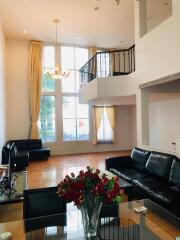 Spacious living room with high ceilings and large windows