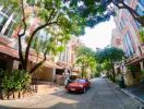 Street view of residential buildings with cars parked