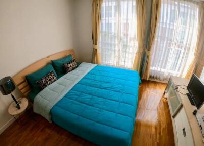 Bedroom with blue bedding and large windows