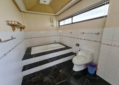 Spacious bathroom with bathtub and modern fixtures