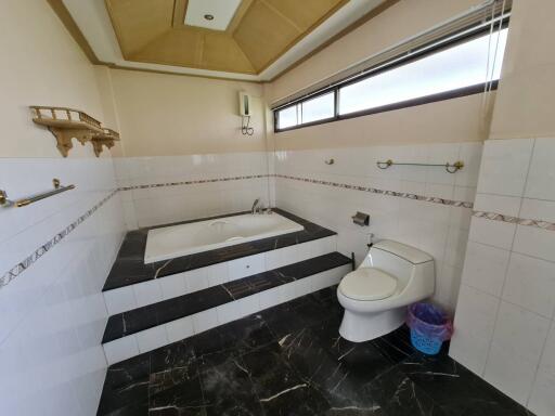 Spacious bathroom with bathtub and modern fixtures