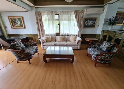 Spacious living room with wooden flooring and classic furniture