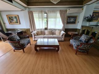 Spacious living room with wooden flooring and classic furniture