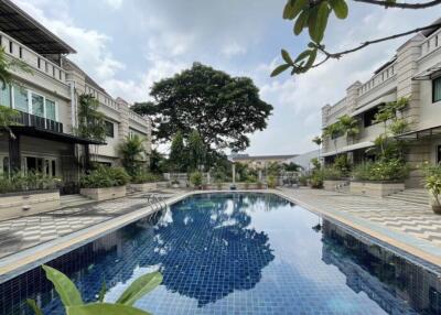 Outdoor pool area with surrounding buildings